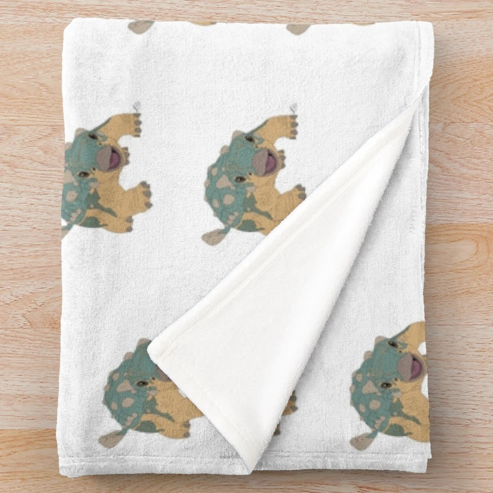 Jurassic plush blanket featuring a bumpy dinosaur design