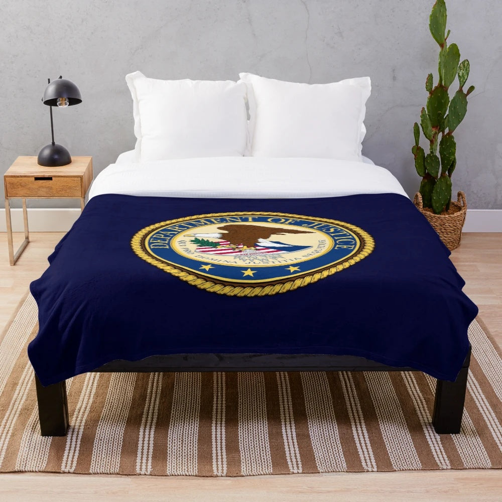 Plush blanket featuring the DOJ seal design, inspired by federal law enforcement