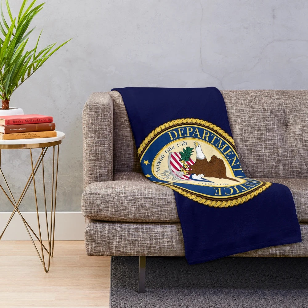 Plush blanket featuring the DOJ seal design, inspired by federal law enforcement