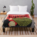 Kaiman the lizard-like character from the anime Dorohedoro eating gyoza on a plush blanket