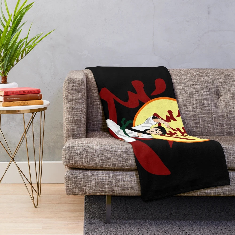 Karate-inspired plush blanket with karateka, chop, and colored belt imagery