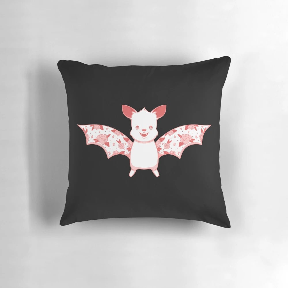 A Kawaii flower bat plush pillow in pink and white colors, perfect for a pastel goth or whimsical bedroom decor.