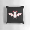 A Kawaii flower bat plush pillow in pink and white colors, perfect for a pastel goth or whimsical bedroom decor.