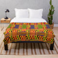 Kente-inspired plush blanket with vibrant ethnic design