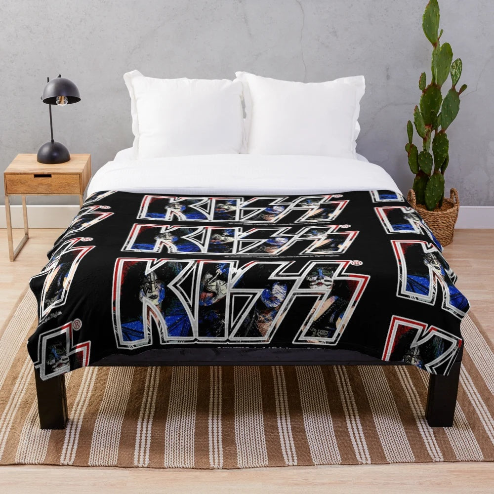 A plush blanket featuring a unique paint-style design of the iconic Kiss band logo