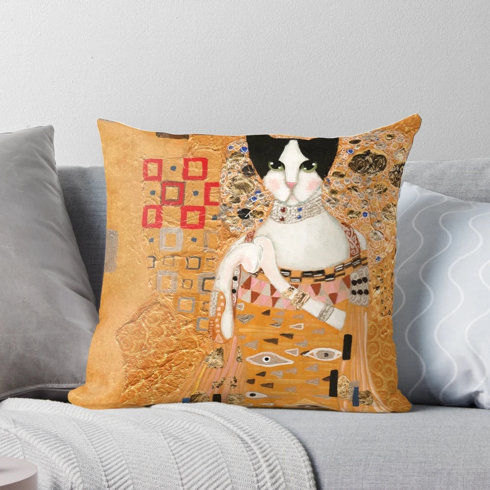 A decorative cat pillow featuring an impressionistic style portrait of a tuxedo cat in gold and earthy tones, inspired by the artwork of Gustav Klimt.