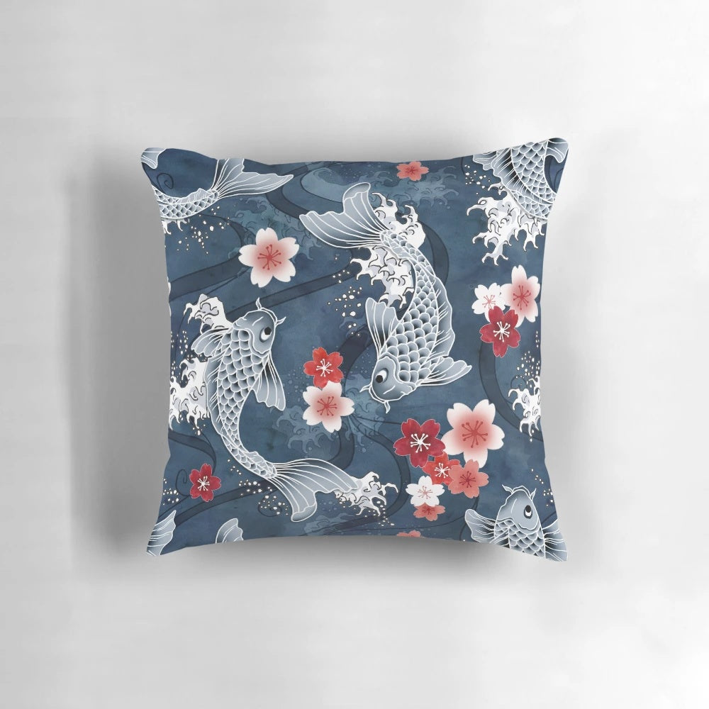 Blue pillow featuring a watercolor design of koi fish swimming among cherry blossoms