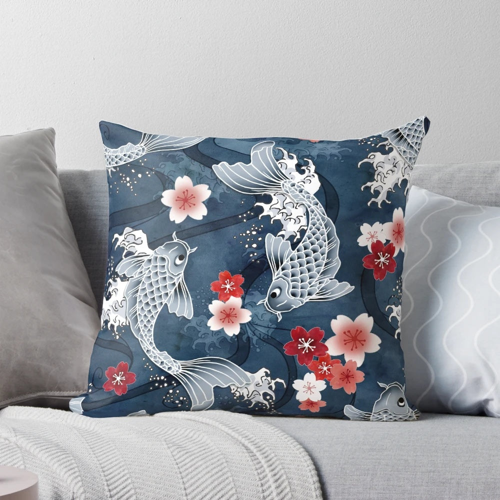 Blue pillow featuring a watercolor design of koi fish swimming among cherry blossoms