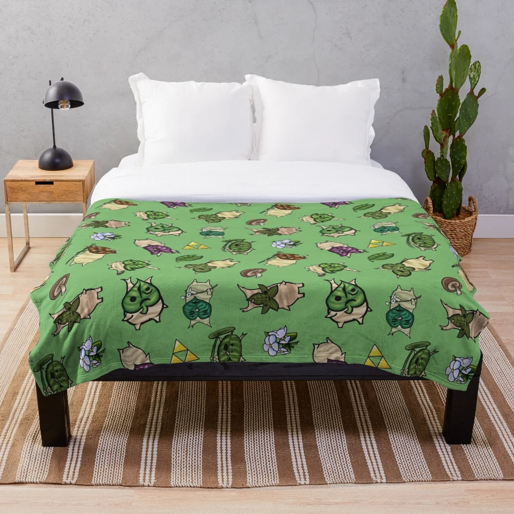 Light green plush blanket with a repeating korok-inspired pattern
