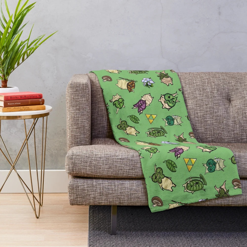 Light green plush blanket with a repeating korok-inspired pattern