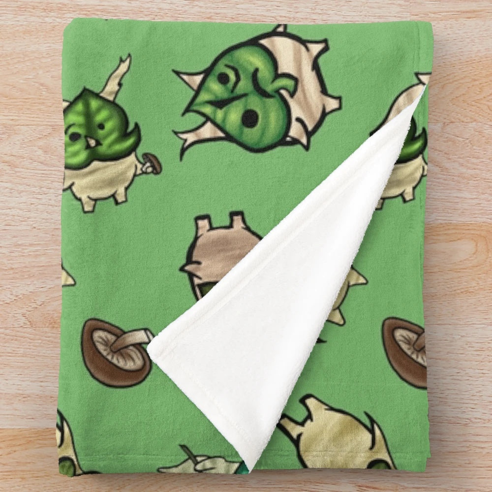 Light green plush blanket with a repeating korok-inspired pattern