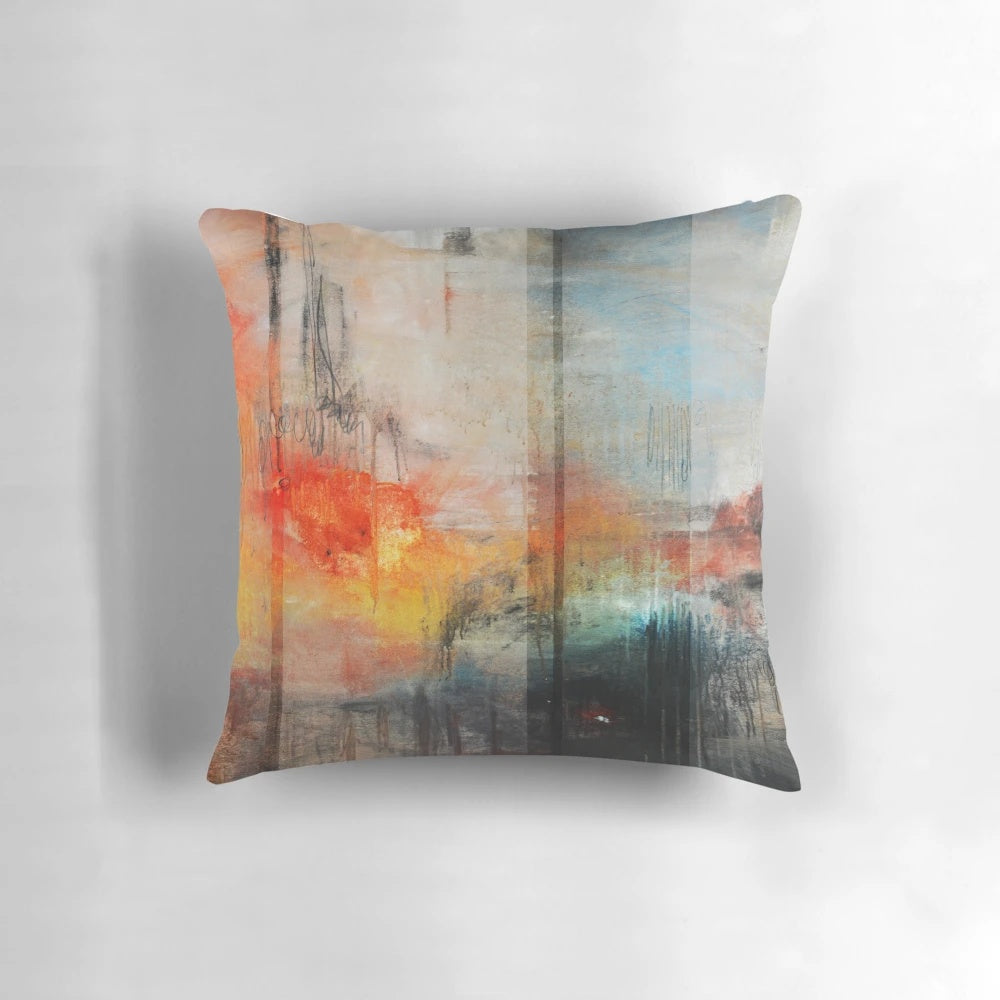Large blue and orange abstract landscape art printed on a decorative throw pillow
