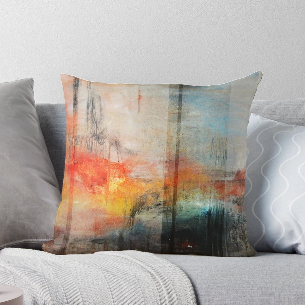 Large blue and orange abstract landscape art printed on a decorative throw pillow