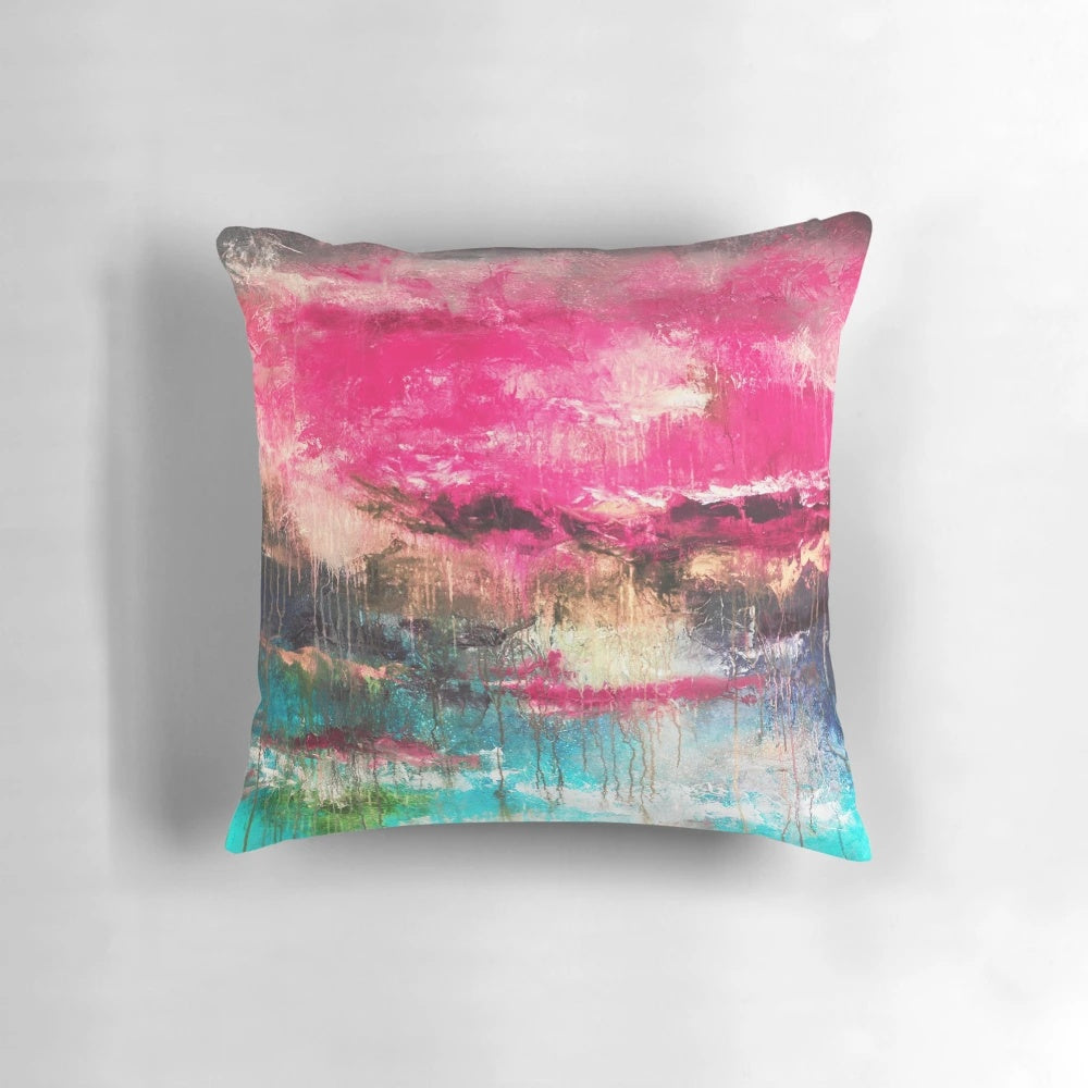 Large decorative abstract art pillow in shades of pink, teal, and fuchsia