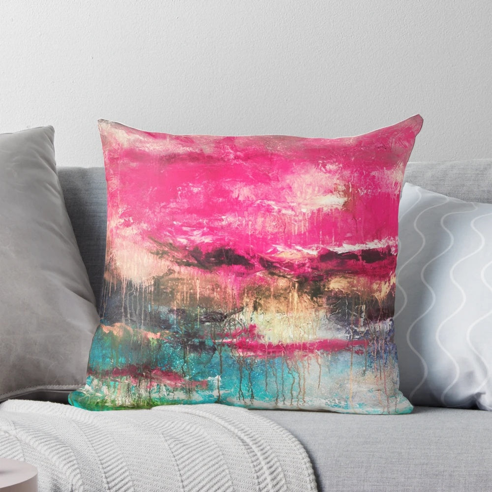 Large decorative abstract art pillow in shades of pink, teal, and fuchsia