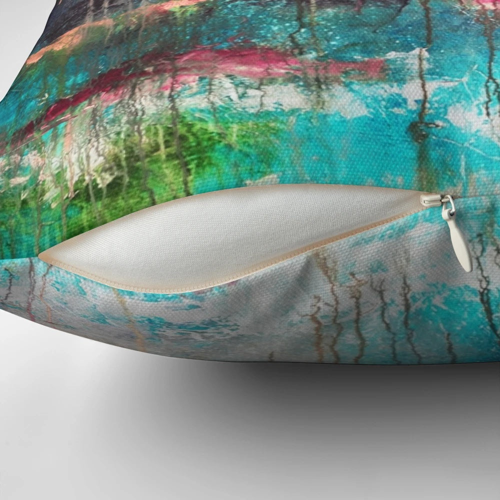 Large decorative abstract art pillow in shades of pink, teal, and fuchsia