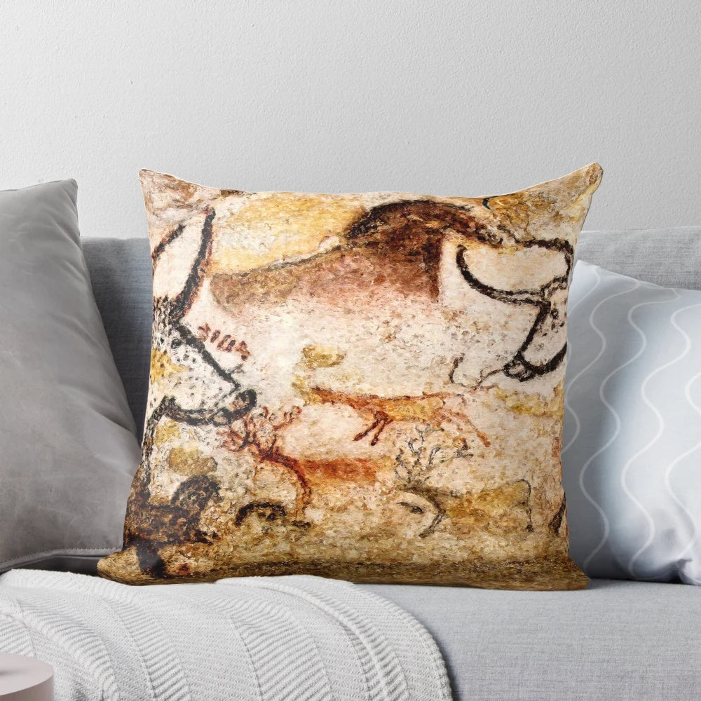 Pillow featuring a reproduction of the Lascaux Hall of the Bulls cave painting, depicting deer and aurochs from the Paleolithic era.