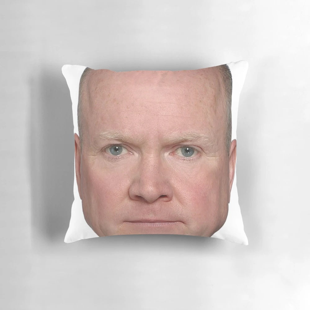 A plush, square pillow featuring the face of Phil Mitchell, a beloved character from the TV show Eastenders.