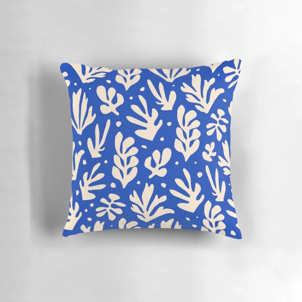 Colorful leaves and plants in a Matisse-inspired pattern on a decorative throw pillow