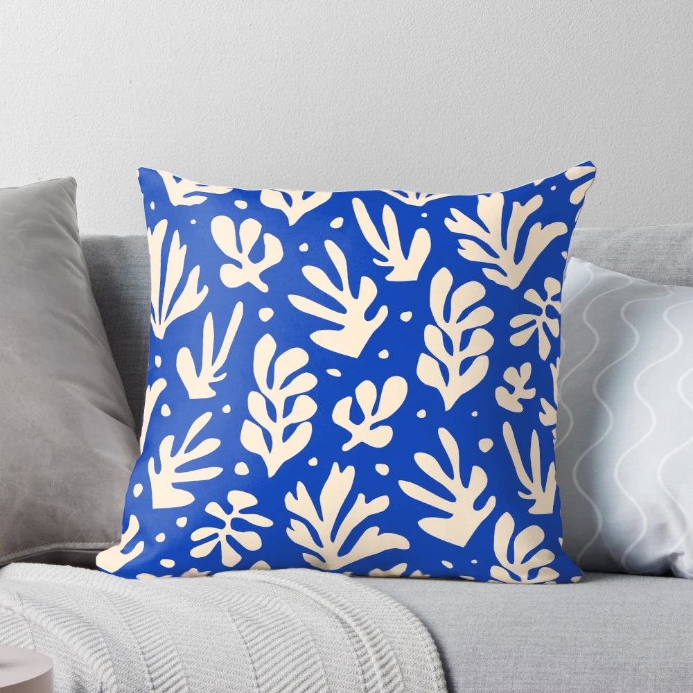 Colorful leaves and plants in a Matisse-inspired pattern on a decorative throw pillow
