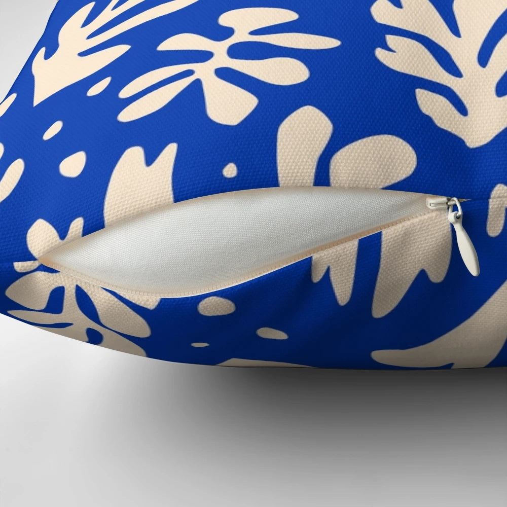 Colorful leaves and plants in a Matisse-inspired pattern on a decorative throw pillow