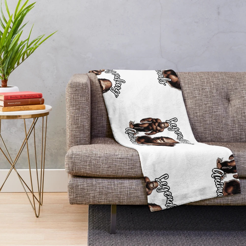 Plush blanket with colorful illustrations of legendary animals like Bigfoot, Sasquatch, and Yeti