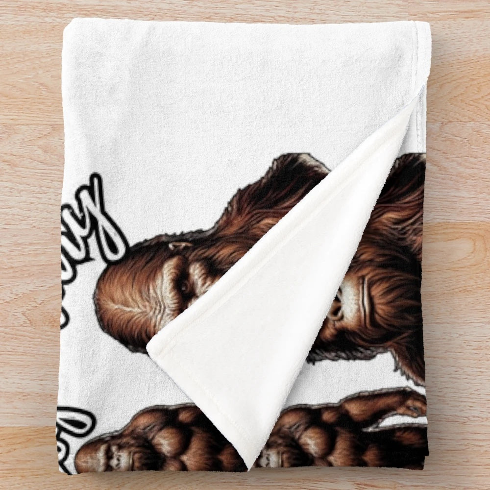 Plush blanket with colorful illustrations of legendary animals like Bigfoot, Sasquatch, and Yeti