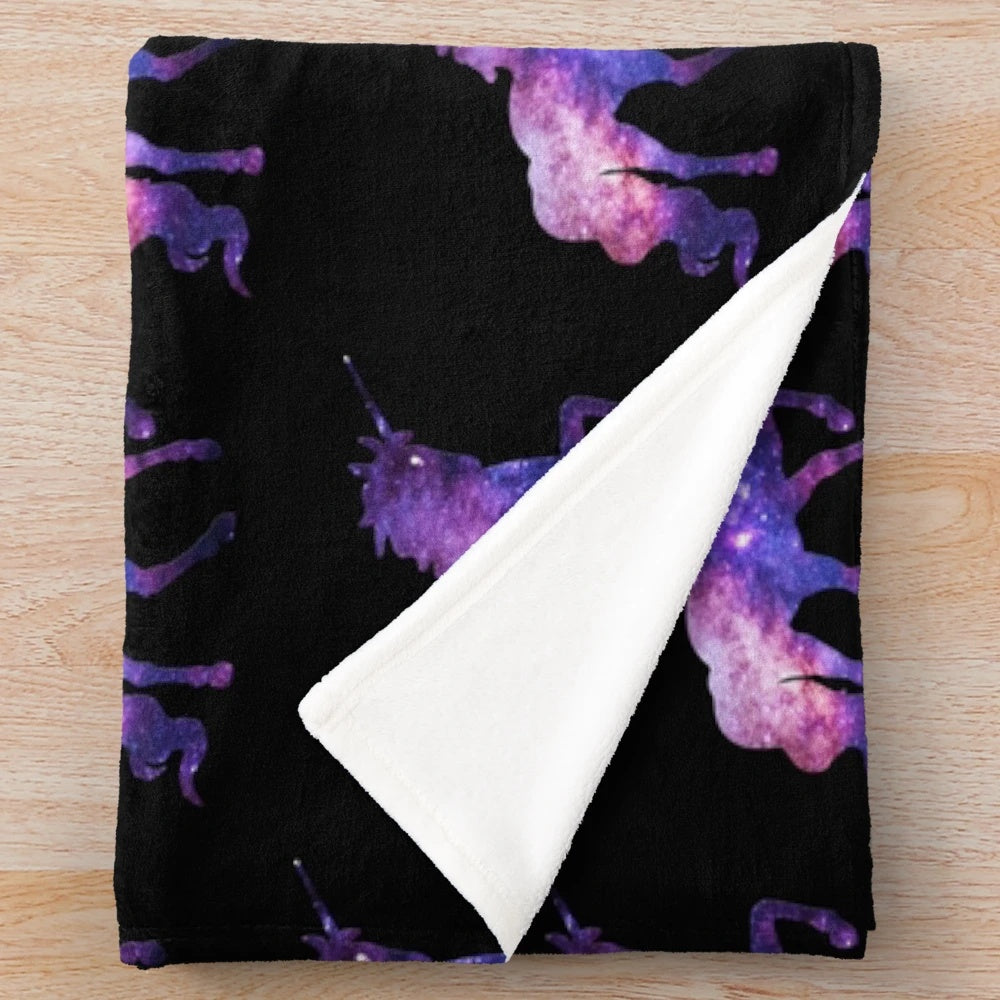 Legendary unicorn silhouette against a starry, cosmic galaxy background on a plush, soft blanket
