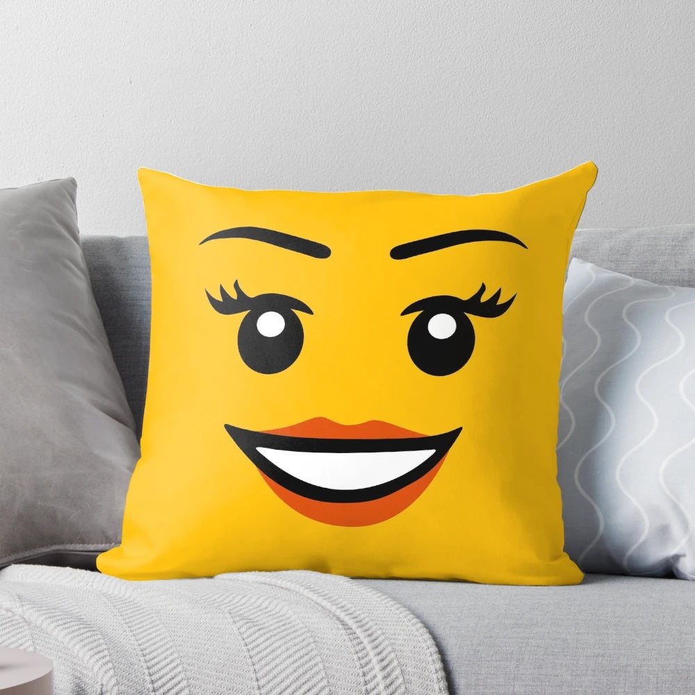 Colorful Lego-style girl face pillow in yellow with a happy, smiling expression.