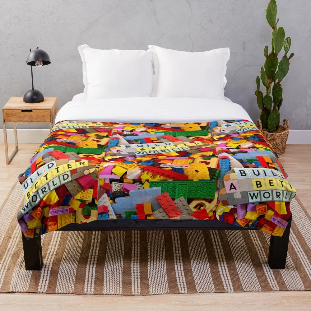 Lego-inspired plush blanket depicting the message "Build a Better World
