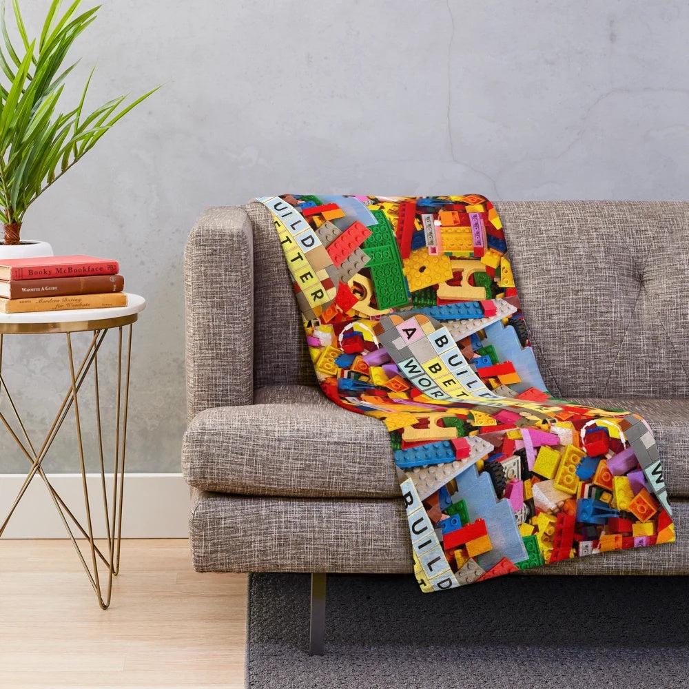 Lego-inspired plush blanket depicting the message "Build a Better World