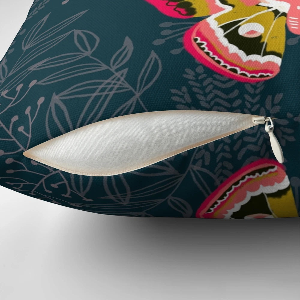 Close-up photograph of a pillow featuring a design of colorful moths and butterflies in a natural, botanical setting.