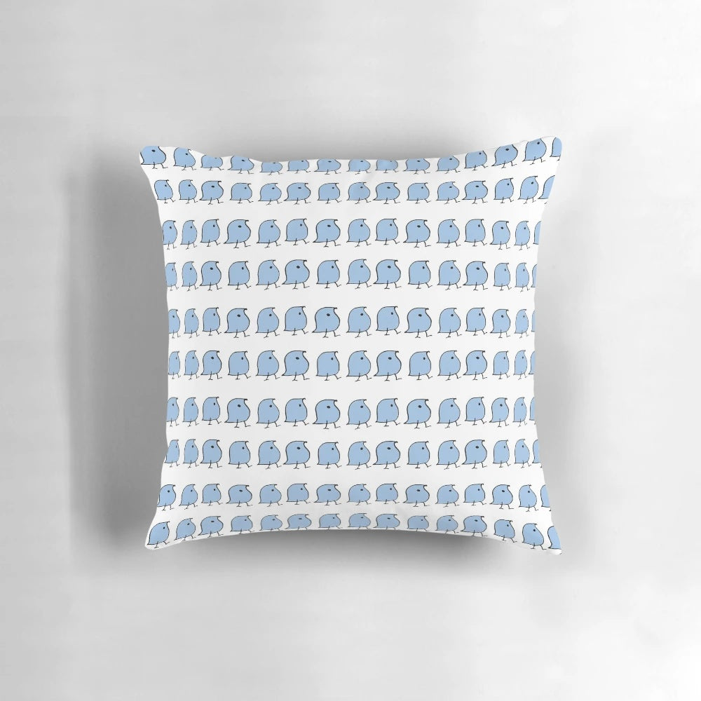 A decorative pillow featuring vibrant blue and white illustrations of the iconic "wug" from linguistics.