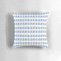 A decorative pillow featuring vibrant blue and white illustrations of the iconic "wug" from linguistics.