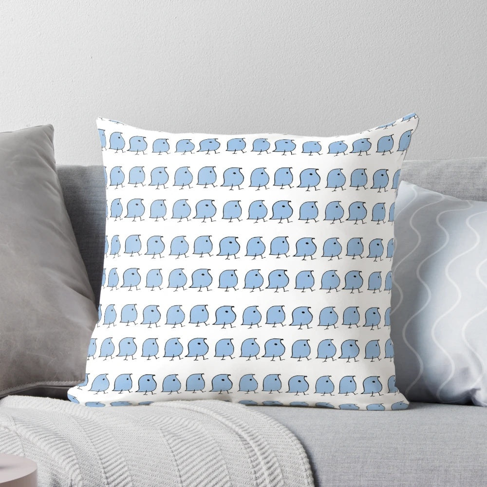 A decorative pillow featuring vibrant blue and white illustrations of the iconic "wug" from linguistics.