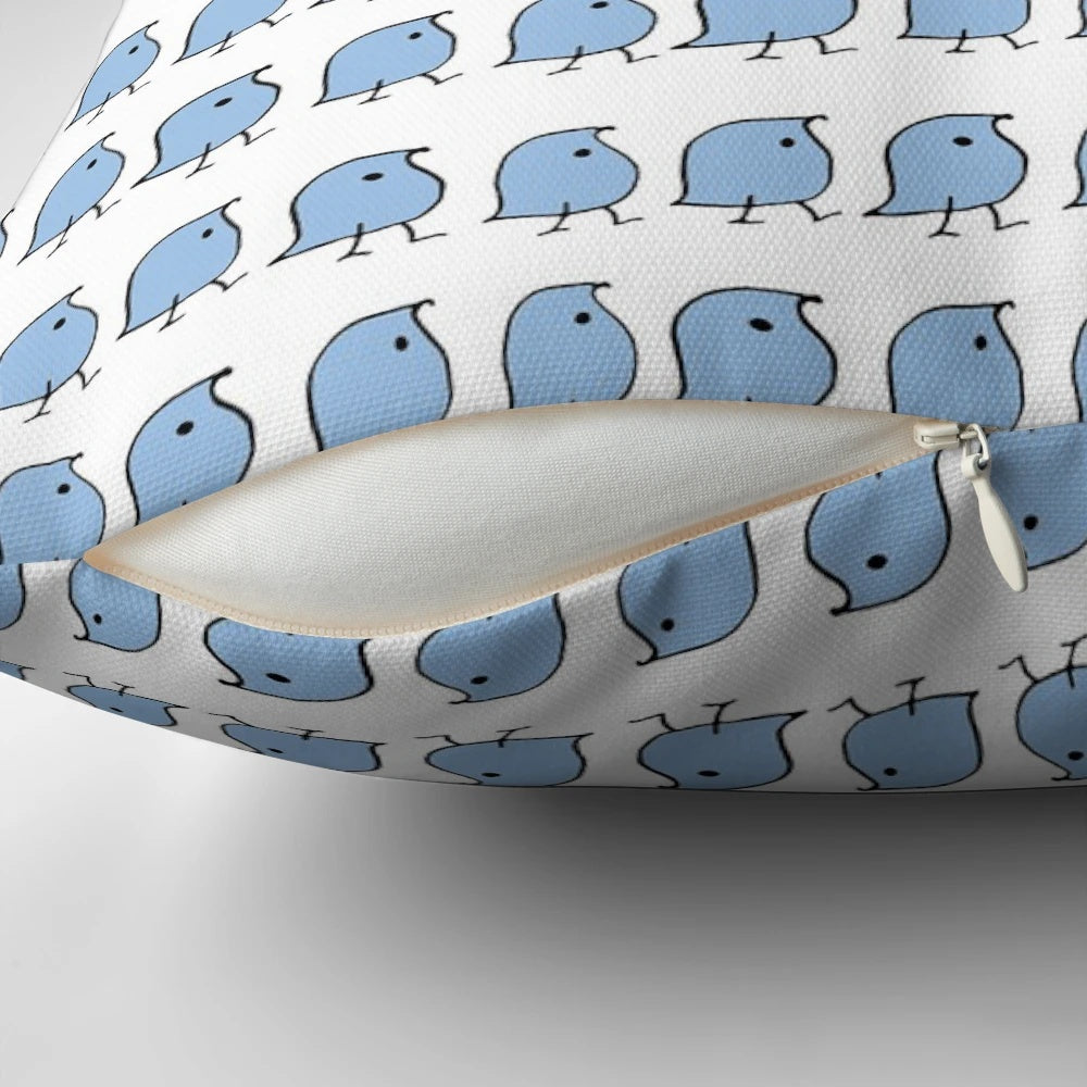 A decorative pillow featuring vibrant blue and white illustrations of the iconic "wug" from linguistics.