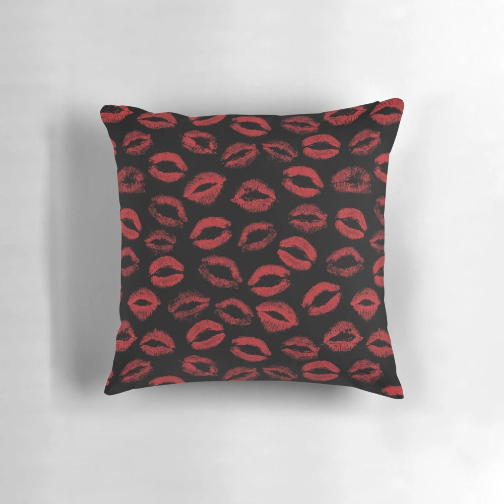 A pillow featuring a repeating pattern of red lipstick marks, creating a textured, seamless design.