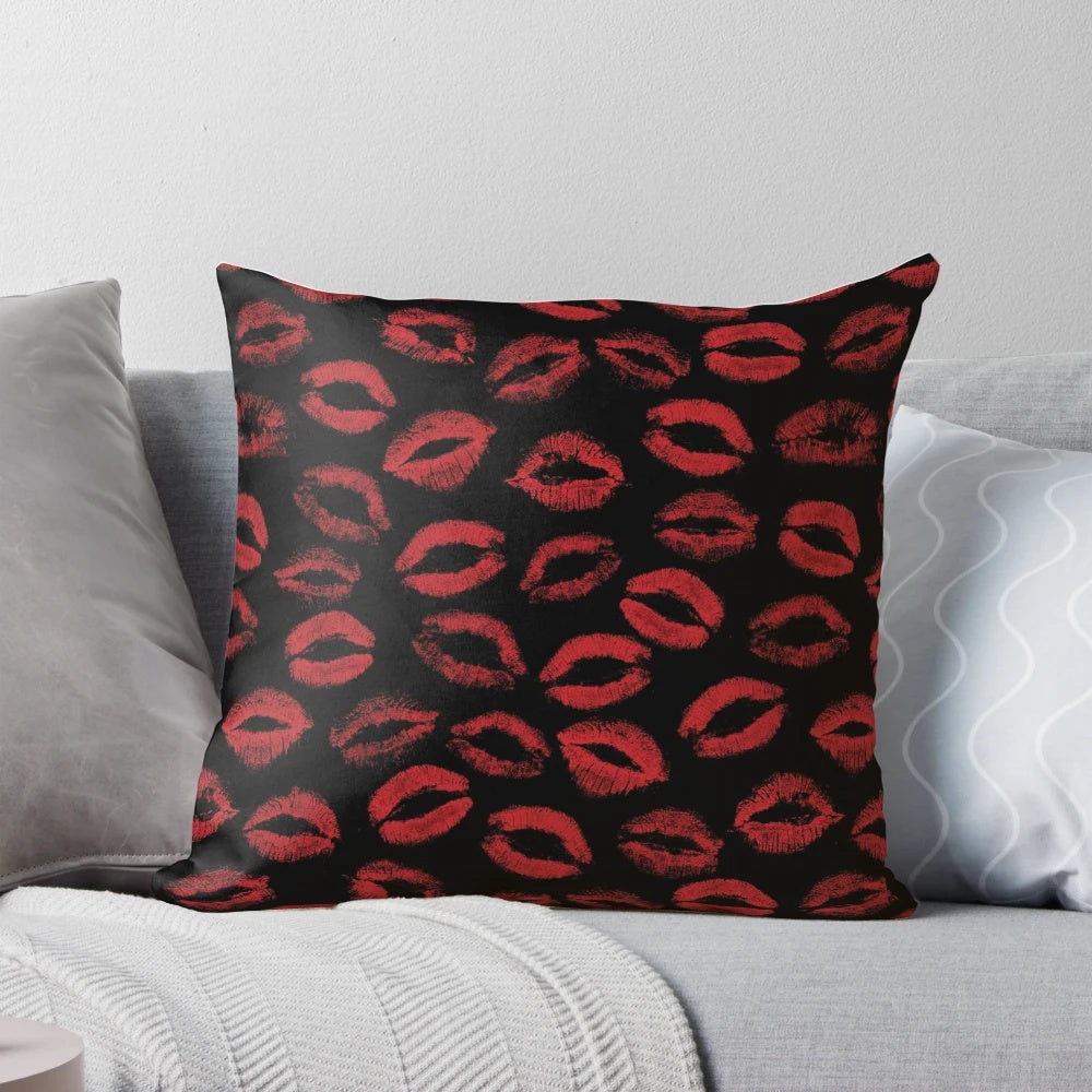 A pillow featuring a repeating pattern of red lipstick marks, creating a textured, seamless design.