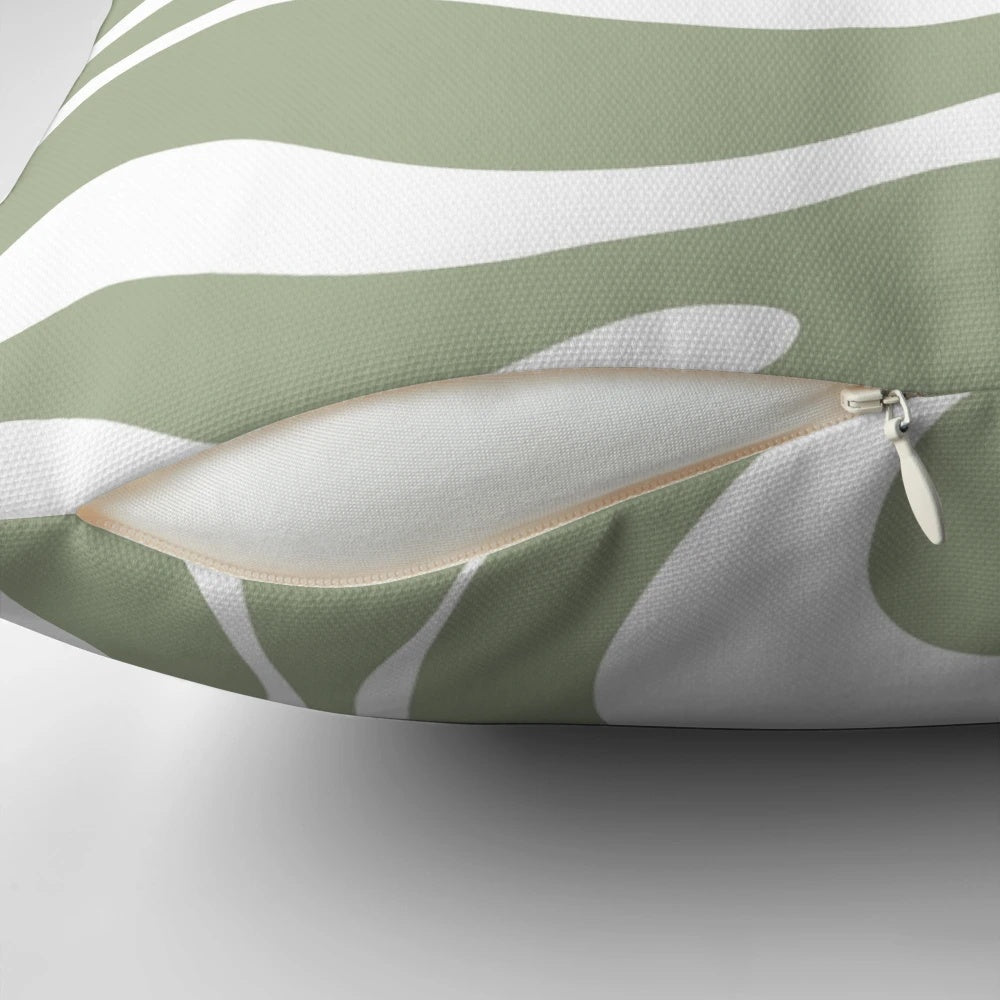 Liquid swirl abstract pattern in sage green and white on a plush pillow