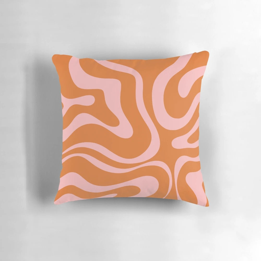 Colorful abstract pattern pillow with a retro liquid swirl design in orange and pink.