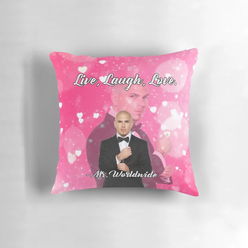 A pink tapestry pillow with the phrase "Live Laugh Love" and a smiling Mr. Worldwide design.