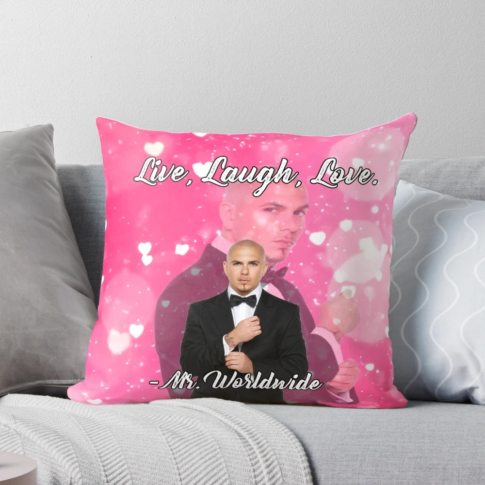 A pink tapestry pillow with the phrase "Live Laugh Love" and a smiling Mr. Worldwide design.