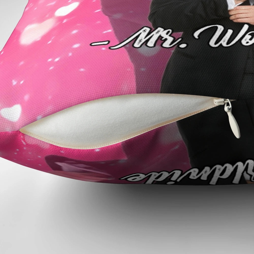 A pink tapestry pillow with the phrase "Live Laugh Love" and a smiling Mr. Worldwide design.