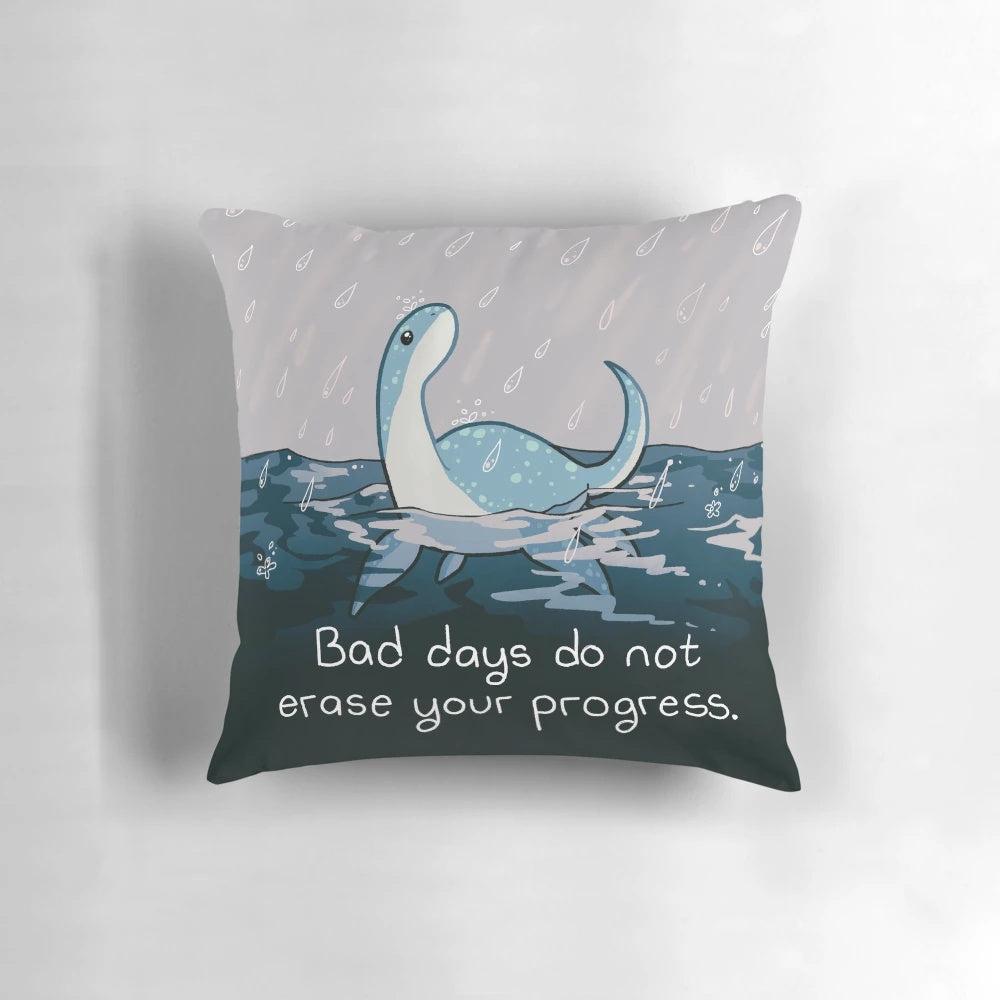 A cozy rainy day pillow featuring the Loch Ness Monster "Nessie" for mental health and wellness.
