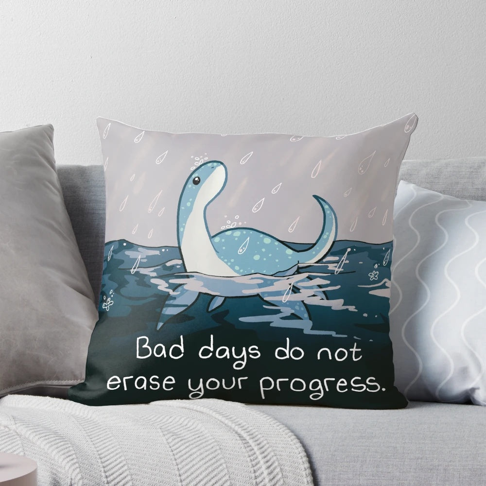 A cozy rainy day pillow featuring the Loch Ness Monster "Nessie" for mental health and wellness.