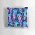Luminescent rainbow jellyfish design on a navy blue pillow, showcasing vibrant colors and a bioluminescent glow.