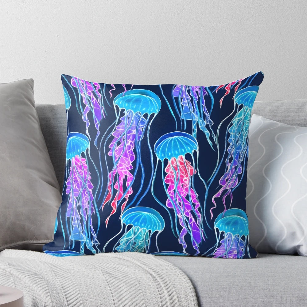 Luminescent rainbow jellyfish design on a navy blue pillow, showcasing vibrant colors and a bioluminescent glow.