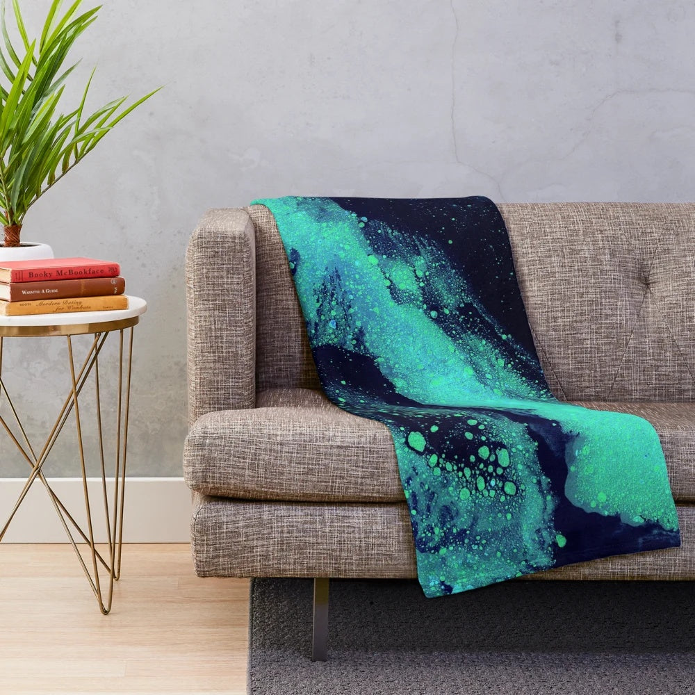 Glow in the dark plush blanket with a cosmic galaxy print design