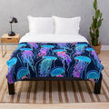 Glowing jellyfish design on a plush navy blue blanket