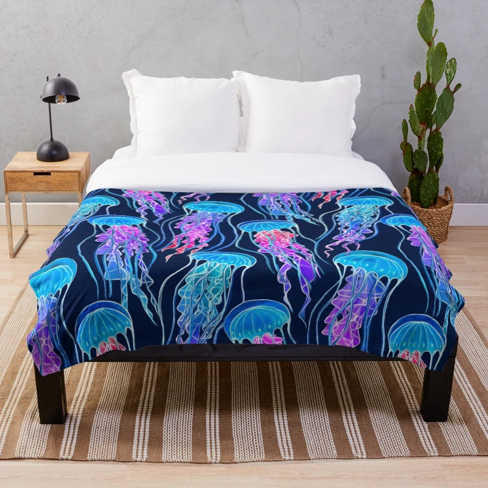 Glowing jellyfish design on a plush navy blue blanket